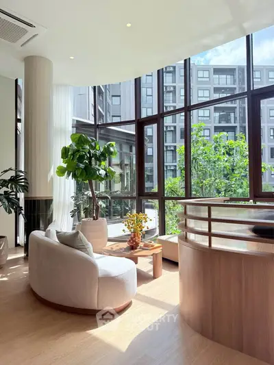 Luxurious living room with floor-to-ceiling windows and modern furniture, offering a stunning view of the cityscape.