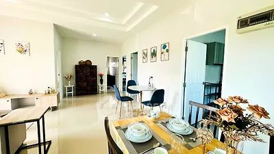 Spacious open-plan living and dining area with modern decor and natural light