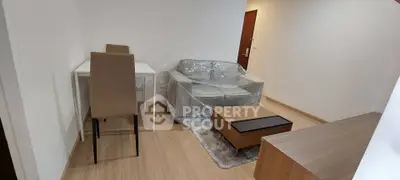 Modern living room with cozy sofa, dining table, and wooden flooring in a stylish apartment.
