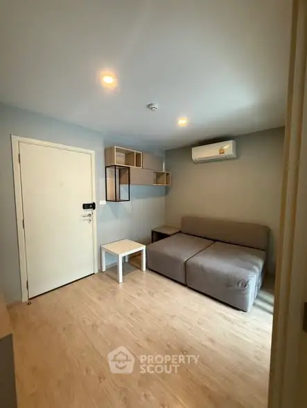 Modern living room with sleek furniture and air conditioning in a cozy apartment.