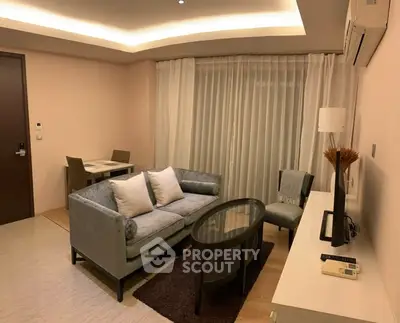 Modern living room with stylish furniture and ambient lighting, perfect for cozy evenings.