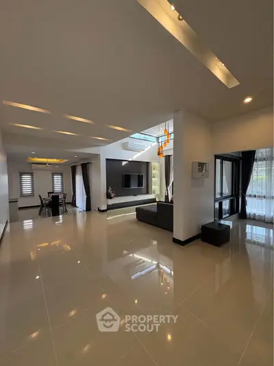 Spacious modern living room with high ceilings and elegant lighting in a luxury home.
