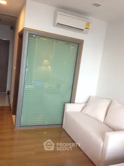 Modern living room with air conditioning and cozy sofa in a stylish apartment