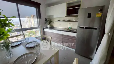 Modern kitchen with dining area and city view, featuring sleek appliances and stylish decor.