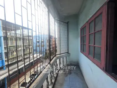 Charming balcony with wrought iron railing and city view, perfect for relaxation and enjoying urban scenery.