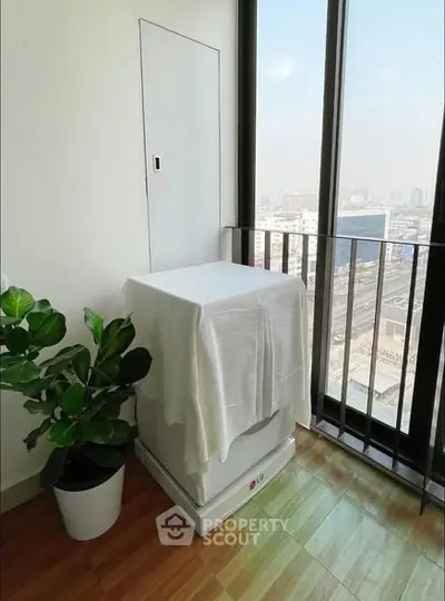 Modern balcony with city view and potted plant