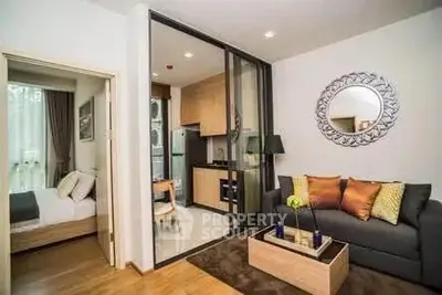Modern living room with open kitchen and cozy bedroom in stylish apartment