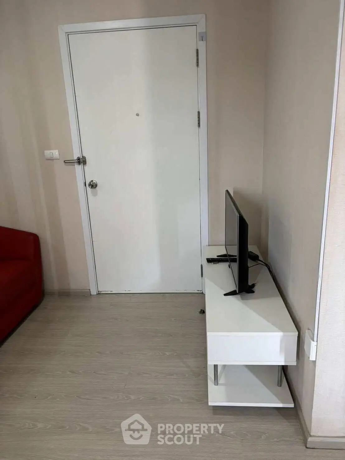 Modern apartment entrance with sleek TV stand and minimalist decor
