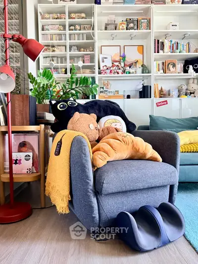 Cozy living room with plush toys, modern decor, and vibrant bookshelf.