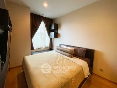 Cozy bedroom with elegant decor and large window for natural light