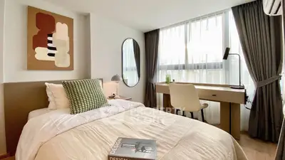 Modern bedroom with stylish decor and large window for natural light