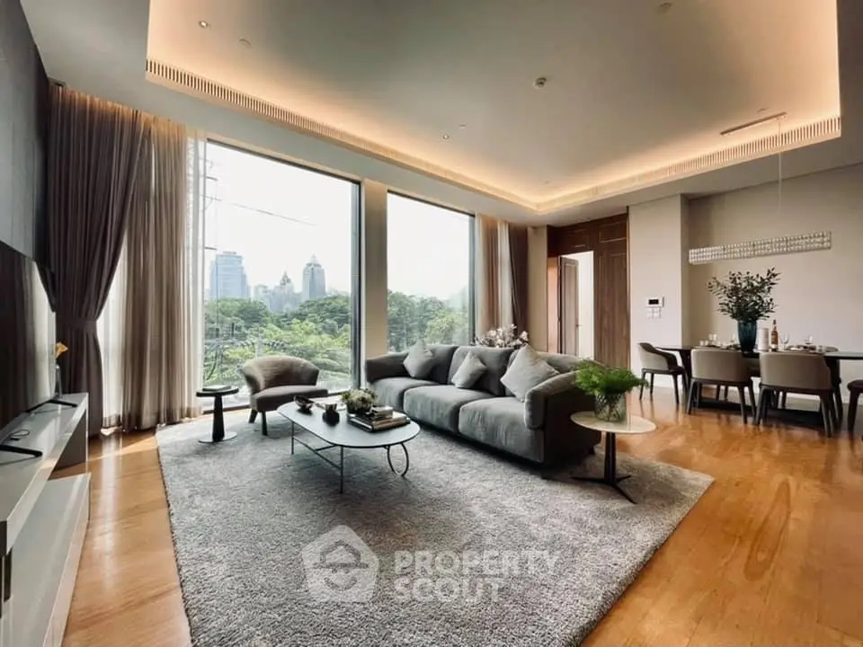 Luxurious living room with panoramic city view, elegant decor, and spacious layout in a high-rise apartment.