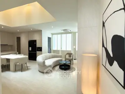 Modern open-plan living room with stylish furniture and contemporary art