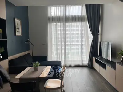 Modern living room with large window and stylish decor in urban apartment