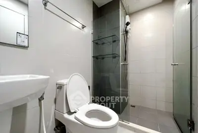 Modern bathroom with sleek shower and elegant fixtures in a contemporary home.