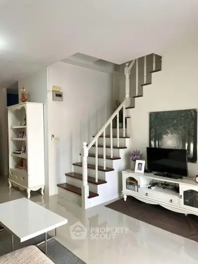 Charming living room with elegant staircase and modern decor