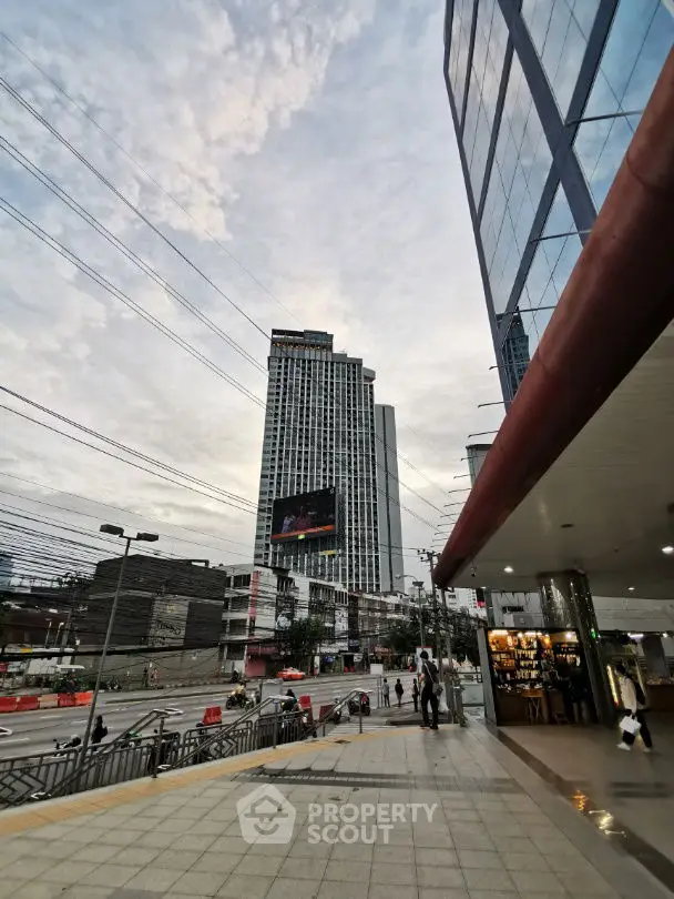 Modern urban building exterior with glass facade and street view