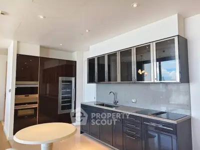 Modern kitchen with sleek cabinetry and built-in appliances in a luxury apartment.