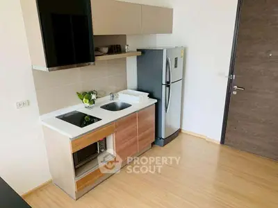 Modern kitchen with sleek appliances and minimalist design in a contemporary apartment.