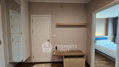 Cozy bedroom with wooden flooring and modern furniture, featuring a comfortable bed and ample storage space.