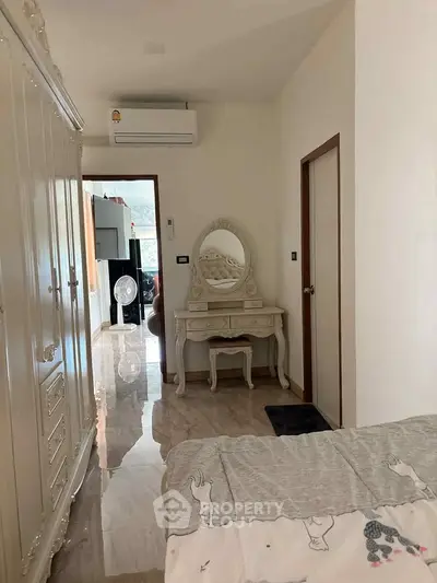 Charming bedroom with elegant furniture and air conditioning, perfect for a cozy retreat.