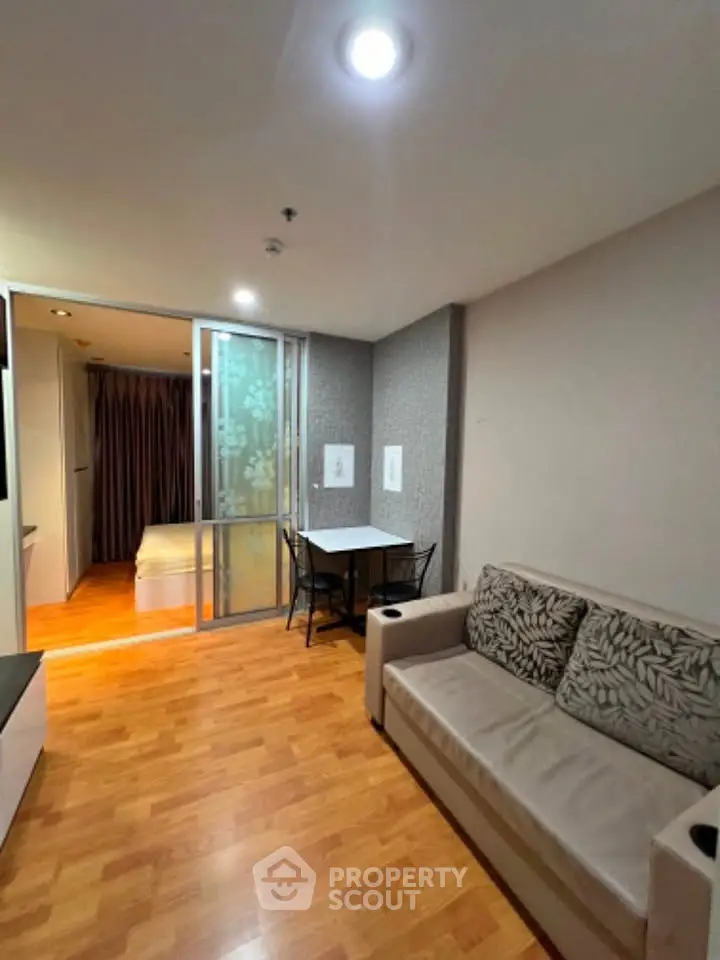 Cozy living room with modern decor and sliding door to bedroom