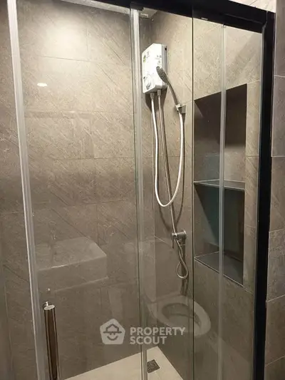 Modern bathroom with glass shower enclosure and sleek tile design
