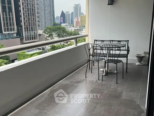 Spacious balcony with city view and elegant outdoor seating.