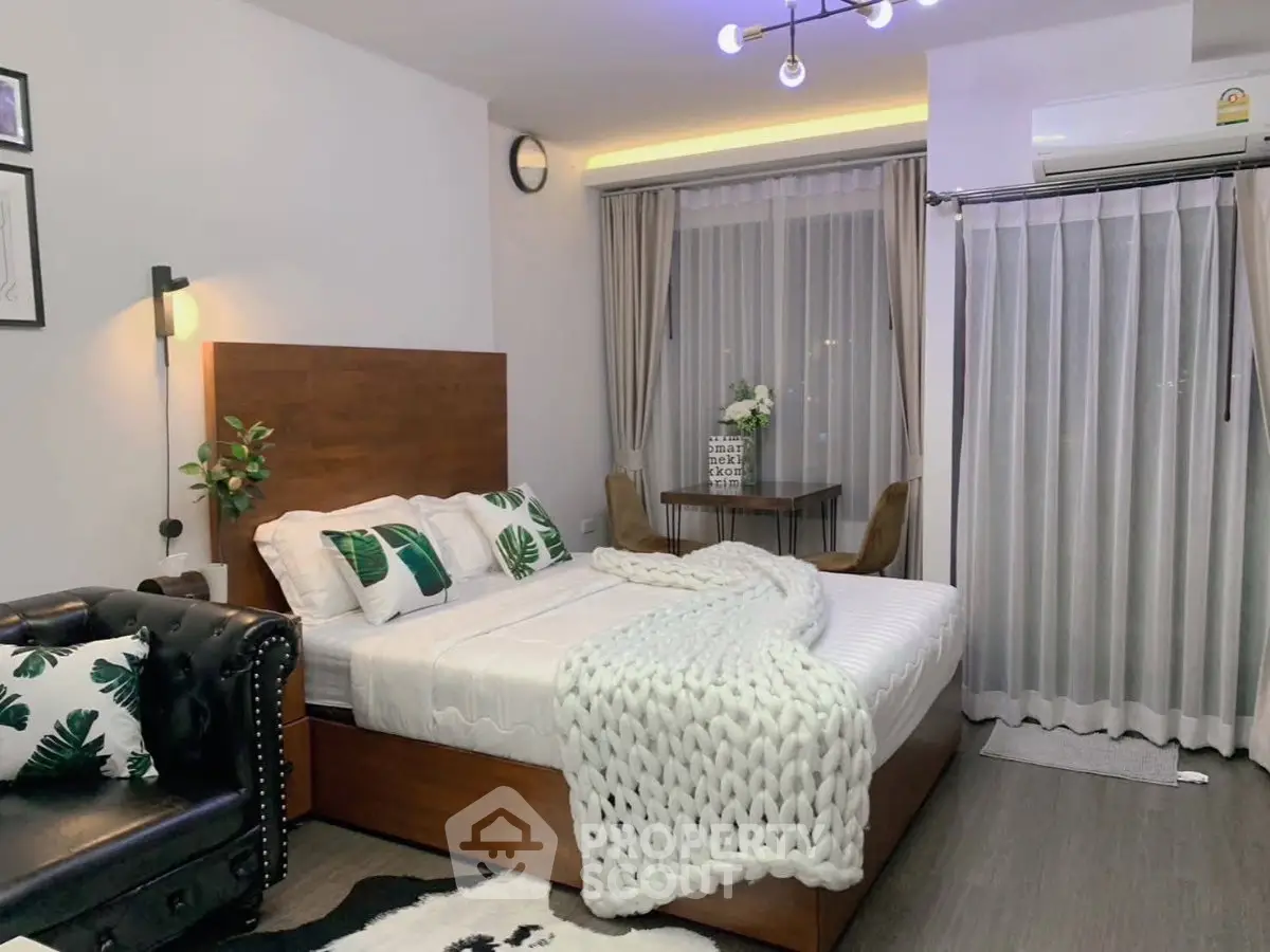 Stylish bedroom with modern decor and cozy ambiance, featuring a plush bed and elegant lighting.