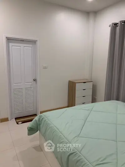 Cozy bedroom with mint green bedding and modern furniture