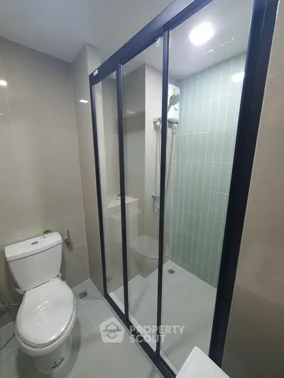 Modern bathroom with sleek shower enclosure and contemporary fixtures.