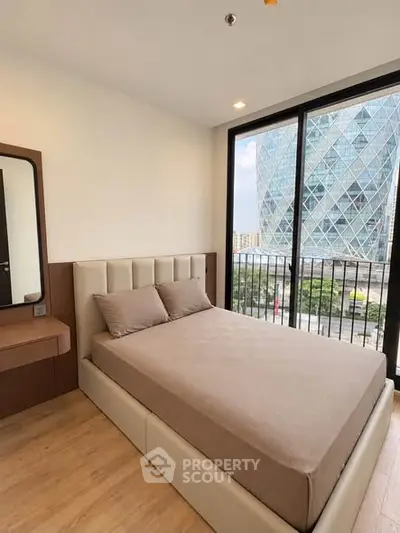 Modern bedroom with large windows offering a stunning city view
