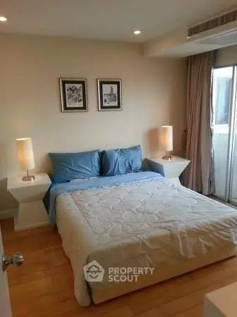 Cozy bedroom with modern decor and natural light, featuring a comfortable bed and stylish bedside lamps.