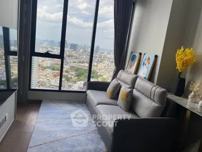 Modern living room with stunning city view from large windows, stylish decor and comfortable seating.
