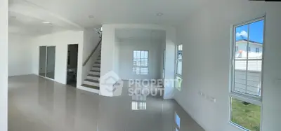Spacious modern living area with glossy tiled floors and large windows