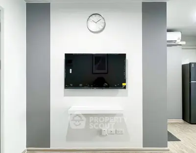 Modern living room with wall-mounted TV and minimalist decor