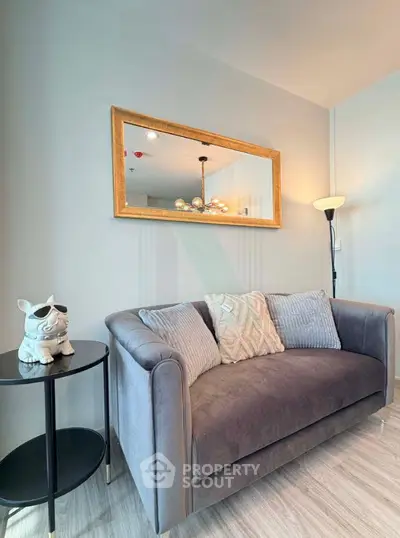 Stylish living room with plush sofa and elegant decor in modern apartment.