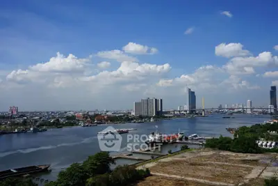 Stunning river view with city skyline and blue sky, perfect for urban living enthusiasts.
