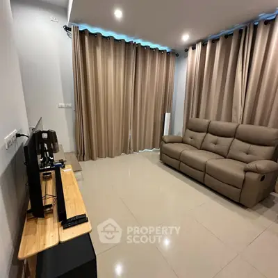 Modern living room with sleek furniture and large windows, perfect for relaxation and entertainment.