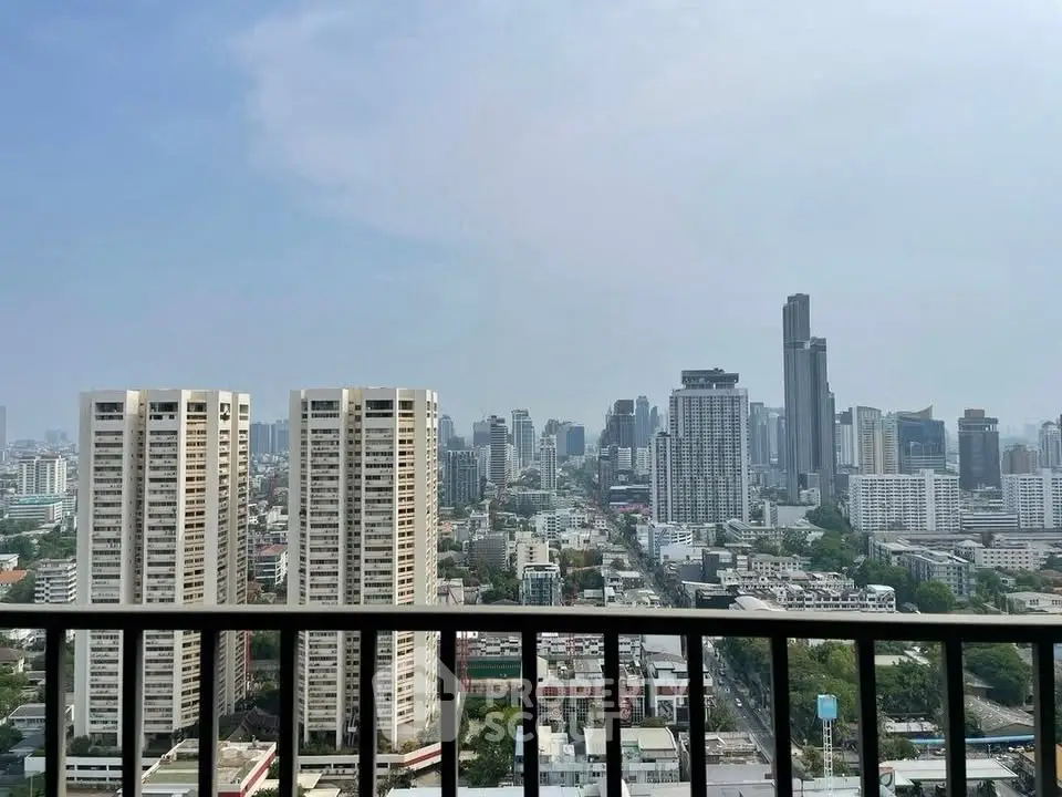 Stunning cityscape view from high-rise balcony overlooking urban skyline.