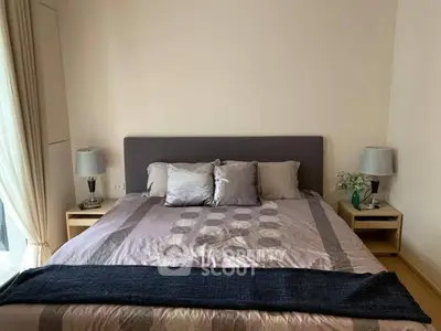 Cozy bedroom with elegant decor and soft lighting, featuring a comfortable bed and stylish bedside tables.