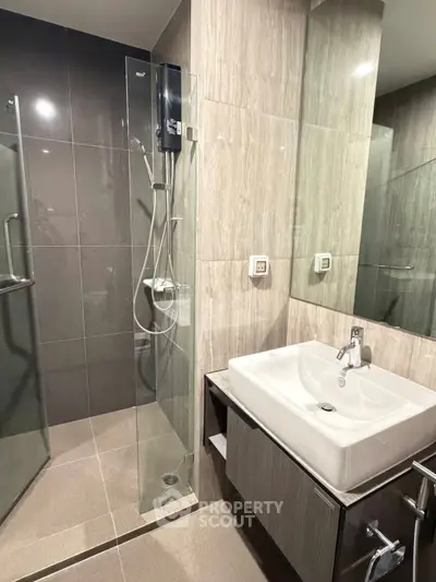 Modern bathroom with sleek shower and stylish sink in contemporary design.