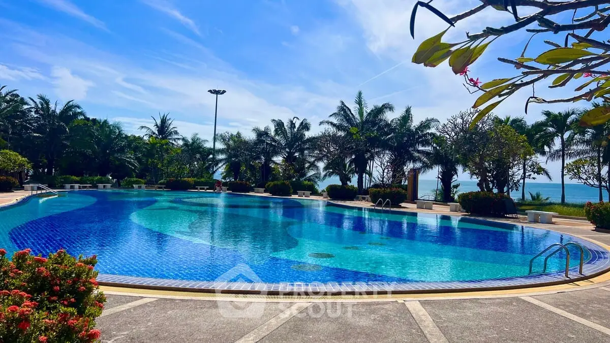 Luxurious outdoor pool with tropical landscaping and ocean view, perfect for relaxation and leisure.