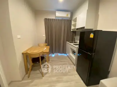 Modern compact kitchen with dining area and sleek appliances