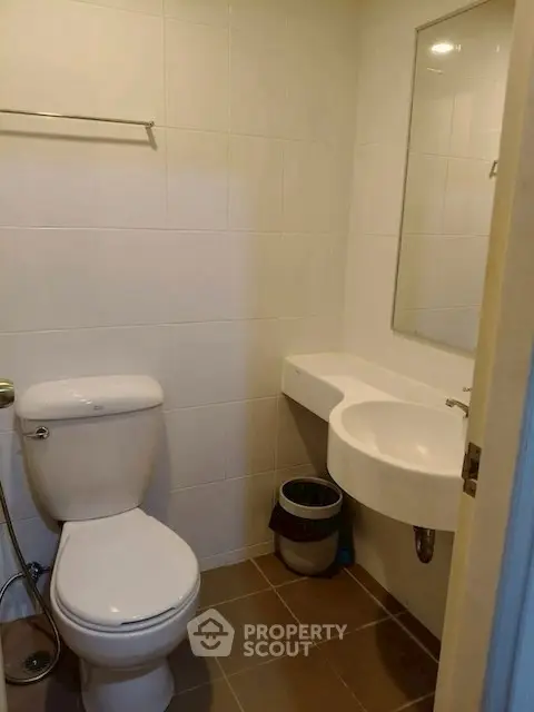 Compact modern bathroom with sleek fixtures and neutral tiles, ideal for urban living.