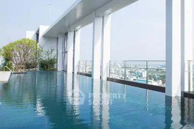 Luxurious rooftop pool with stunning city views in modern high-rise building.