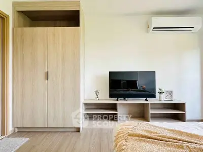 Modern bedroom with sleek wooden furniture and air conditioning, perfect for comfort and style.