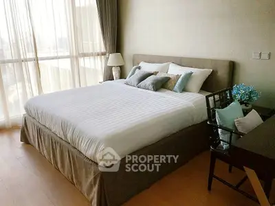 Elegant bedroom with large window and stylish decor in modern apartment