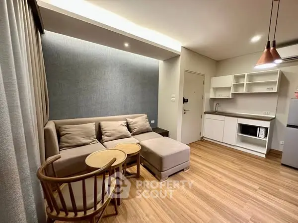 Modern living room with cozy sofa and open kitchen layout, perfect for urban living.