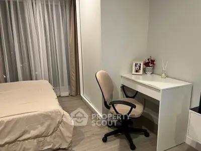 Cozy bedroom with study area featuring a desk and chair, perfect for work-from-home setup.